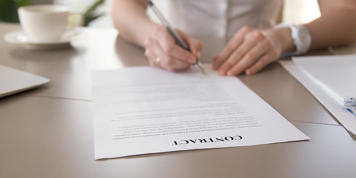 A woman signing a contract - New life of Gemma Massey